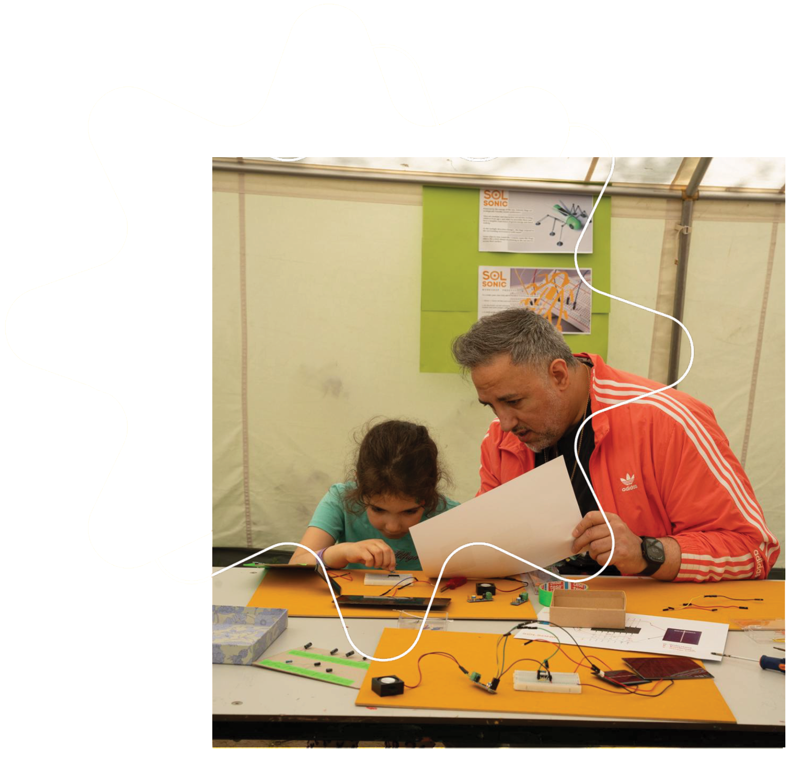 A father and daughter building a Solsonic circuit together